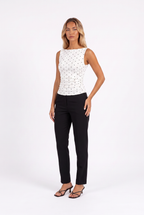 White polka-dot boat-neck sleeveless top with tie back — three-quarter